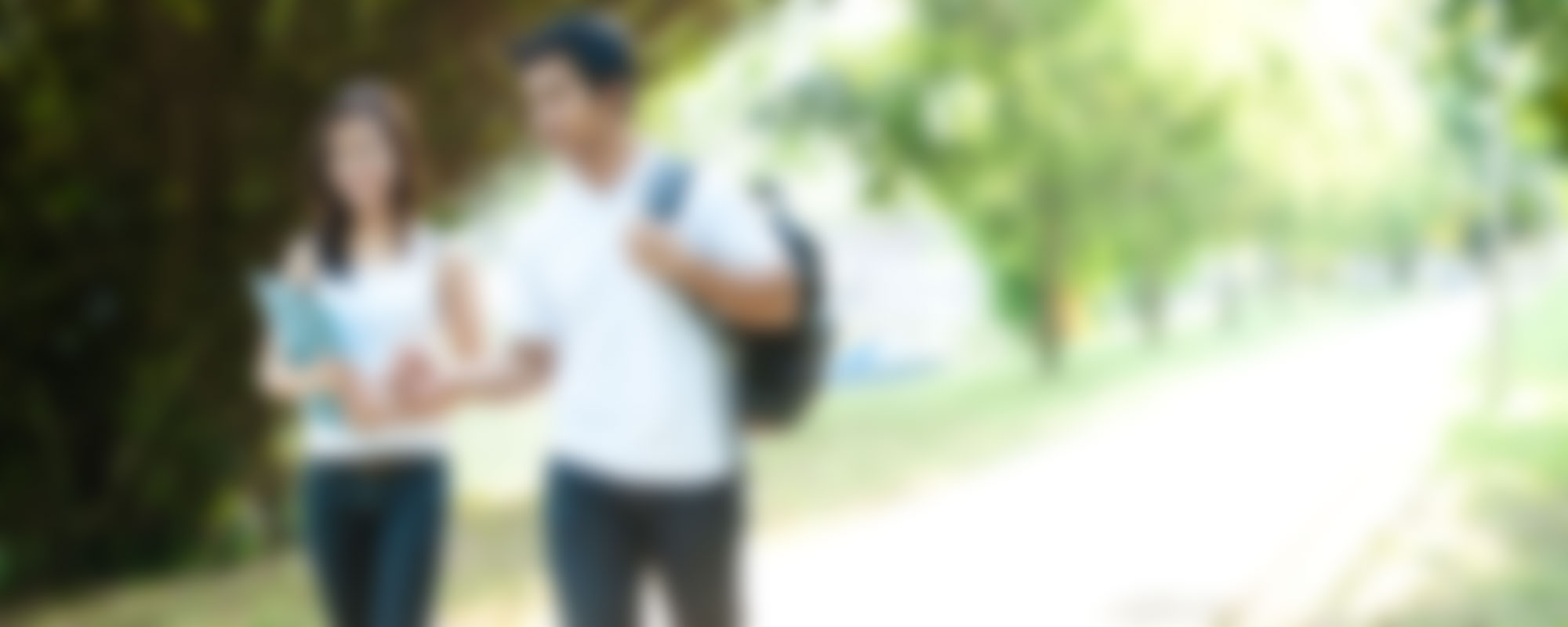 A blurry photo of two students walking together