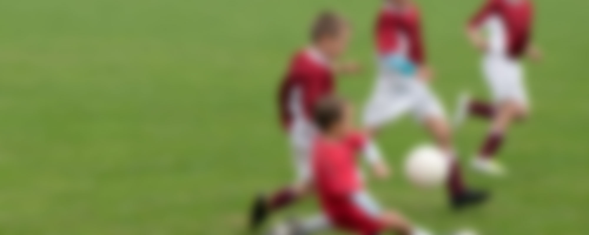 A blurry photo of kids playing soccer